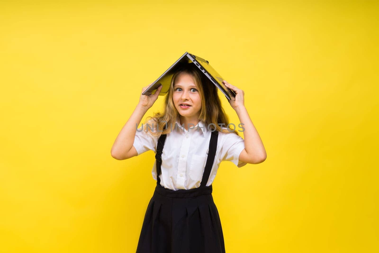 Little happy blonde kid girl 12-13 years laptop computer. Children lifestyle childhood concept.