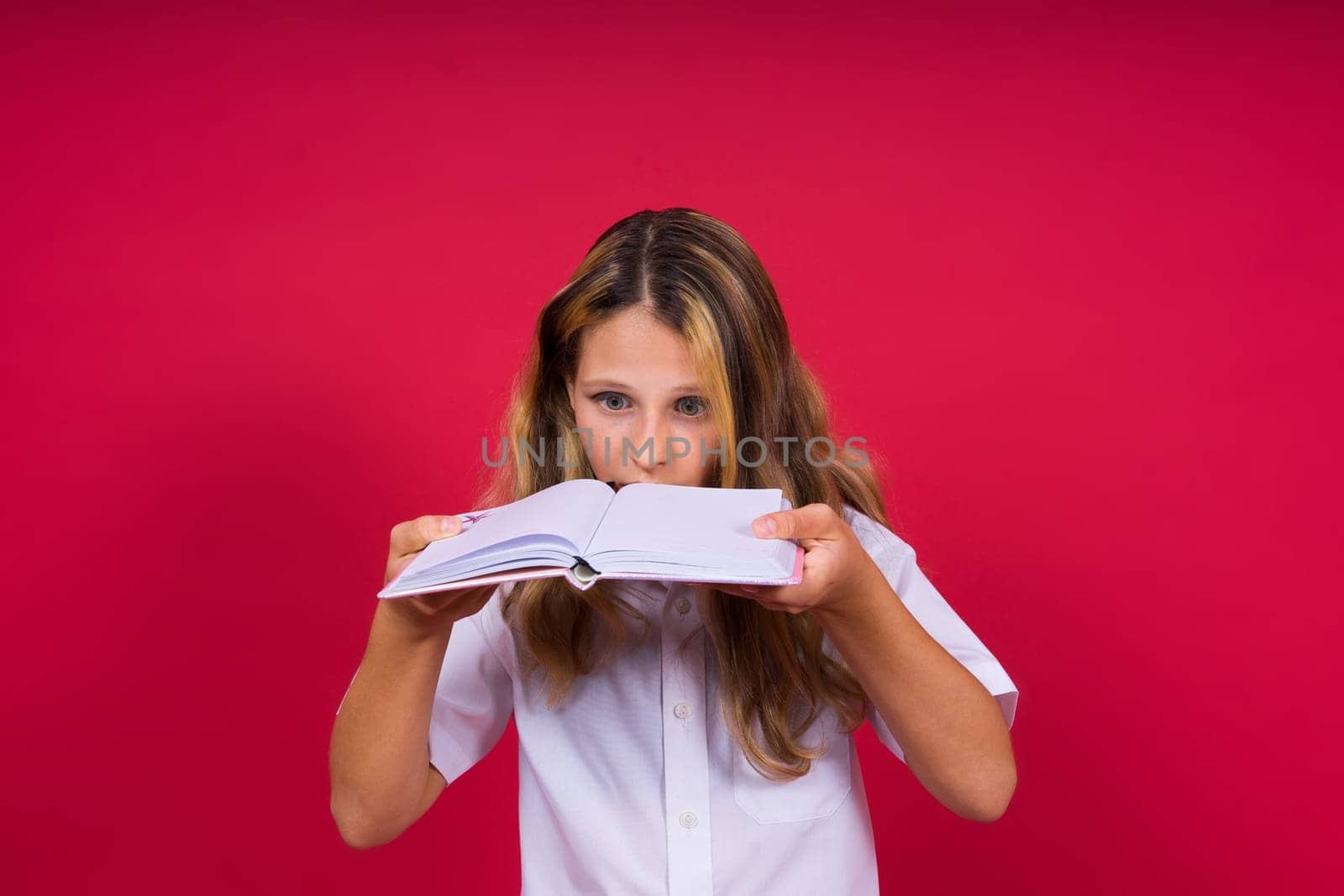 Child making notes. Kids dreams.Isolated on red background. Education, Kid back to school. by Zelenin