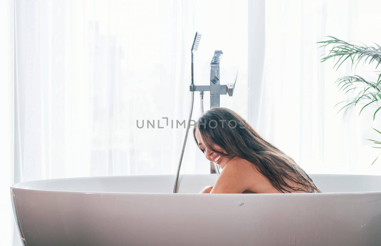 Beautiful young woman have free time at home in the bath.