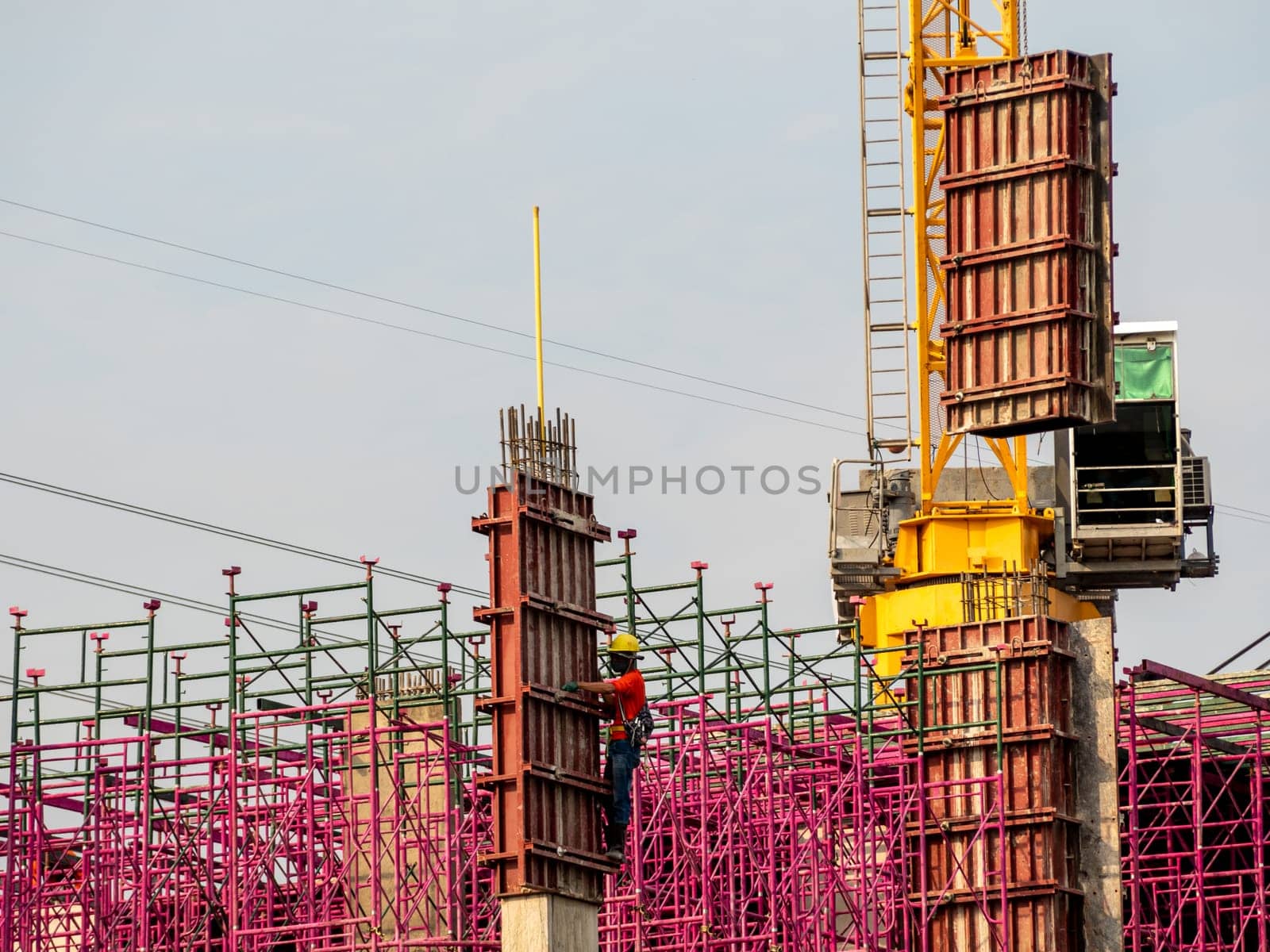 The pink scaffolding on the building under construction