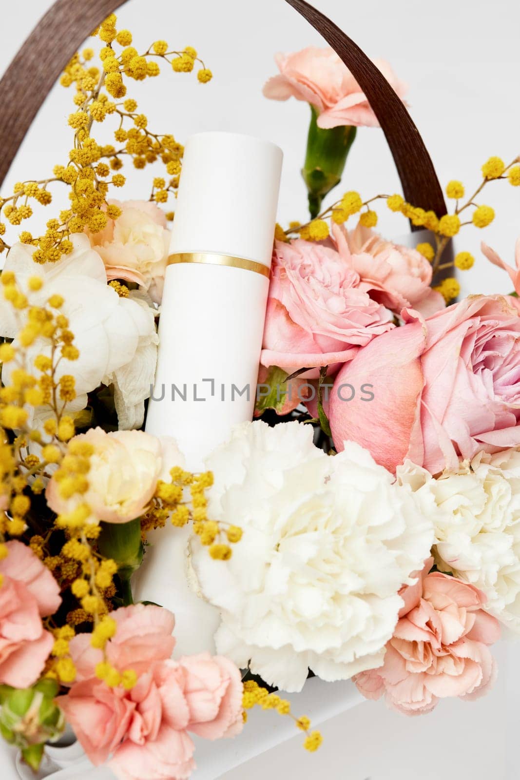 cosmetic bottle mockup with natural ingredient and blooming pink flowers. Natural organic beauty product