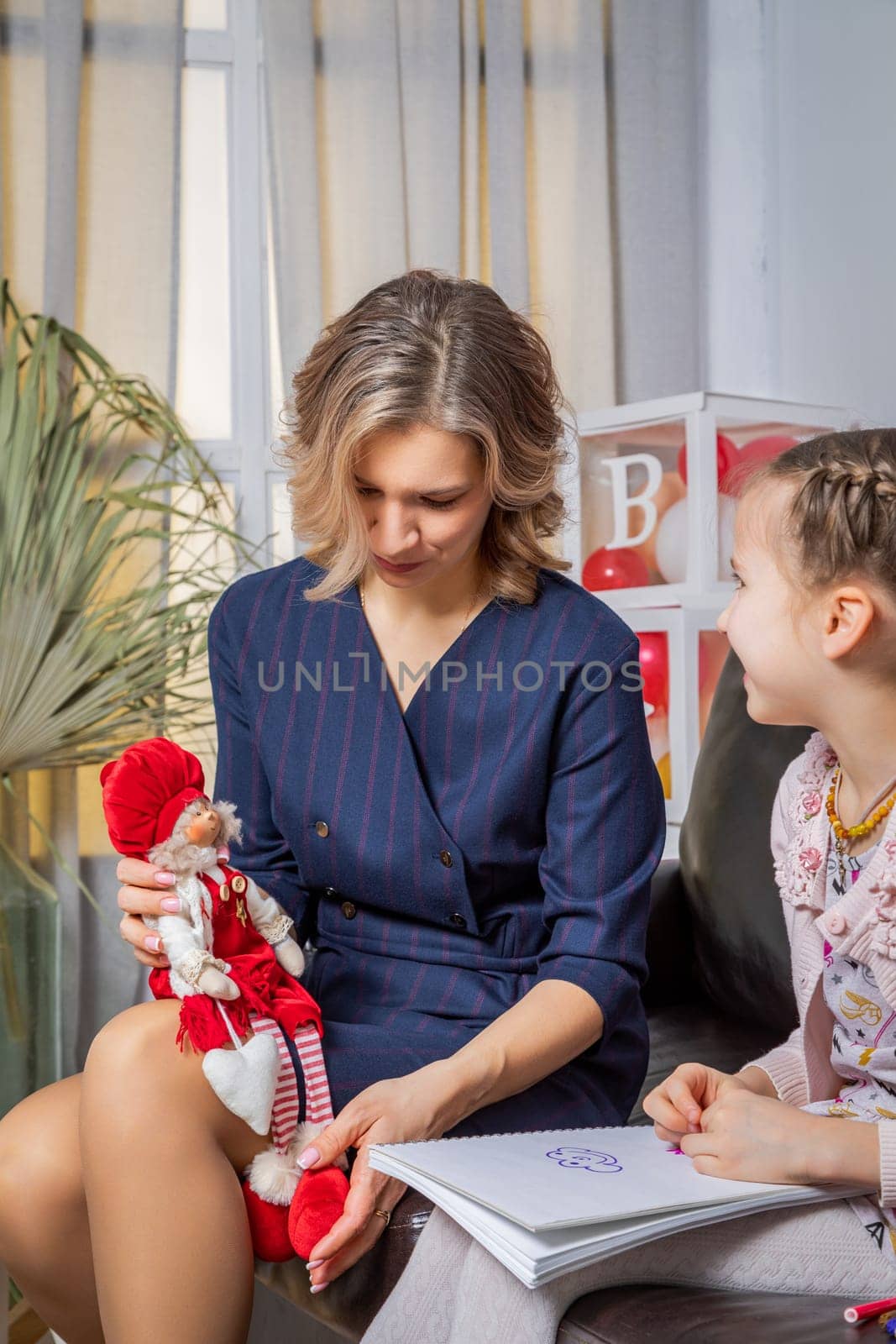 The girl psychologist plays a puppet character game with the child. by Yurich32