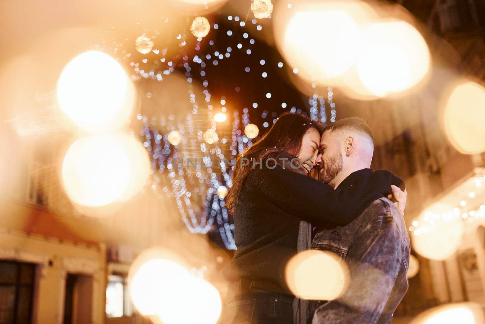 Happy multiracial couple together outdoors in the city celebrating New year.
