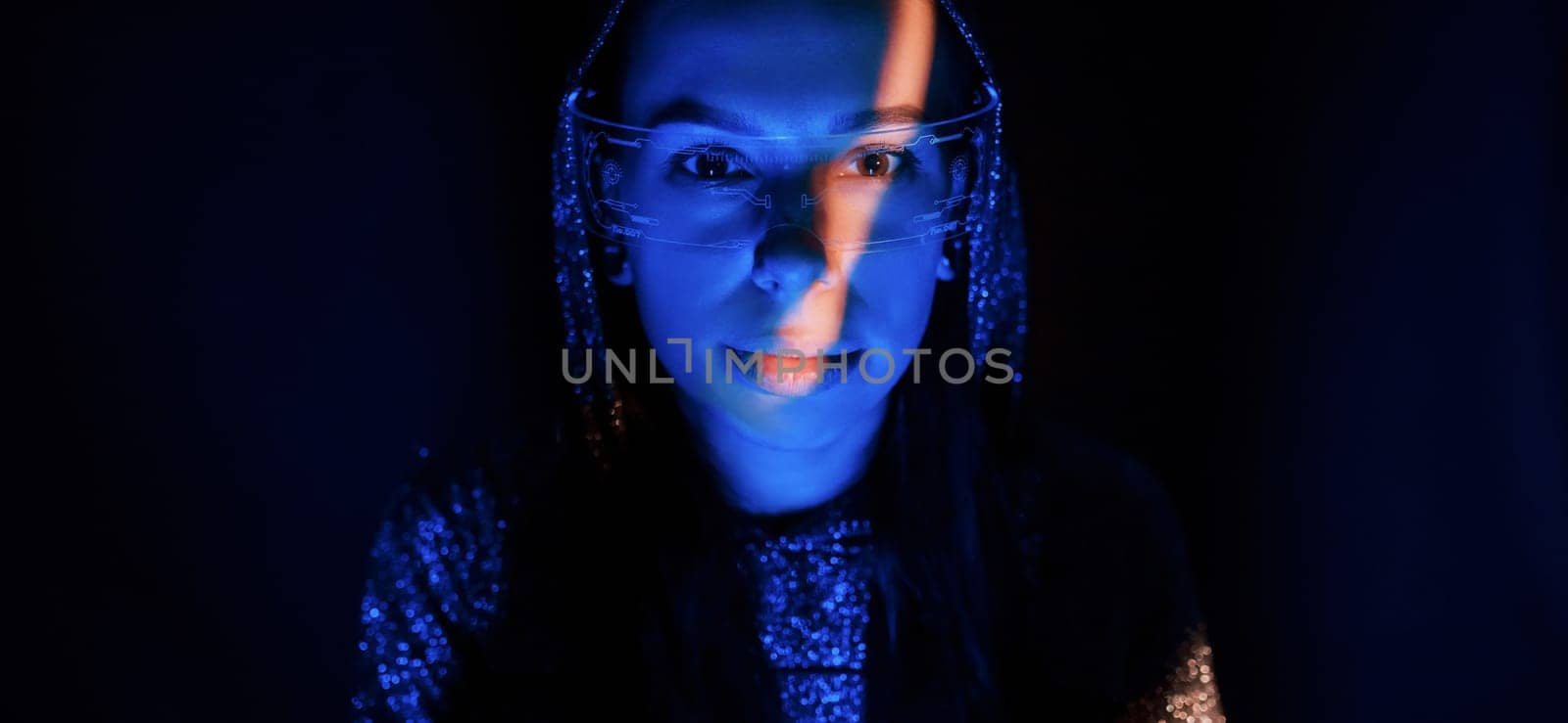 Portrait of young girl that is in eyeglasses in blue neon lighting.