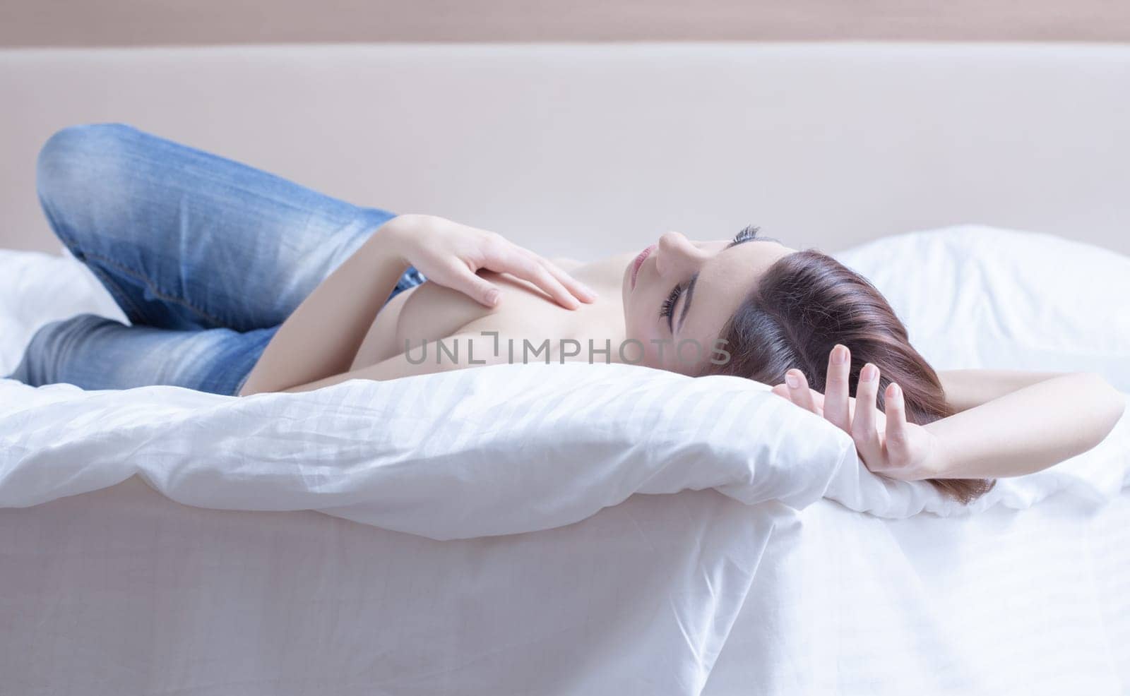 Portrait of sexy woman relaxing in bedroom