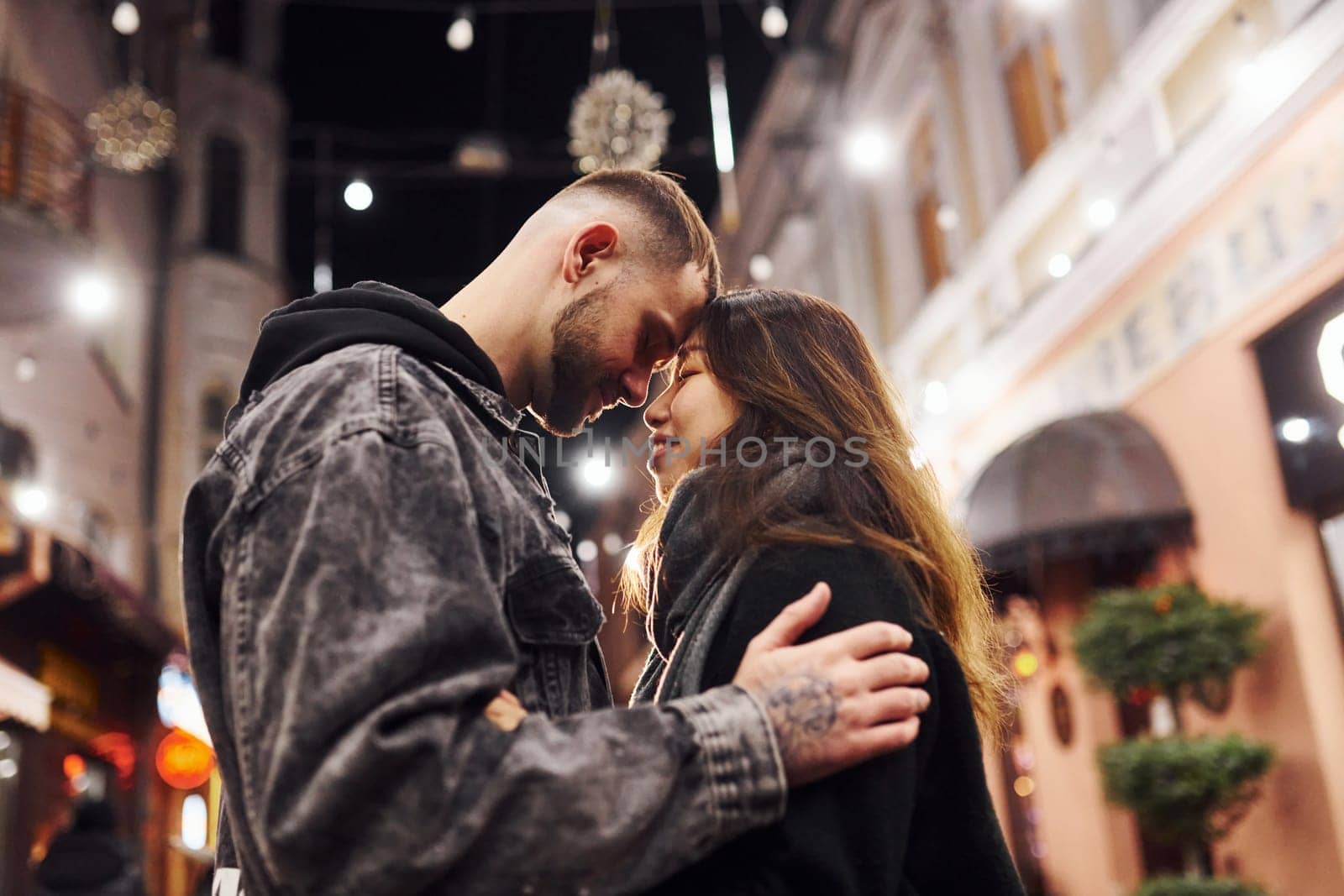 Happy multiracial couple together outdoors in the city celebrating New year.