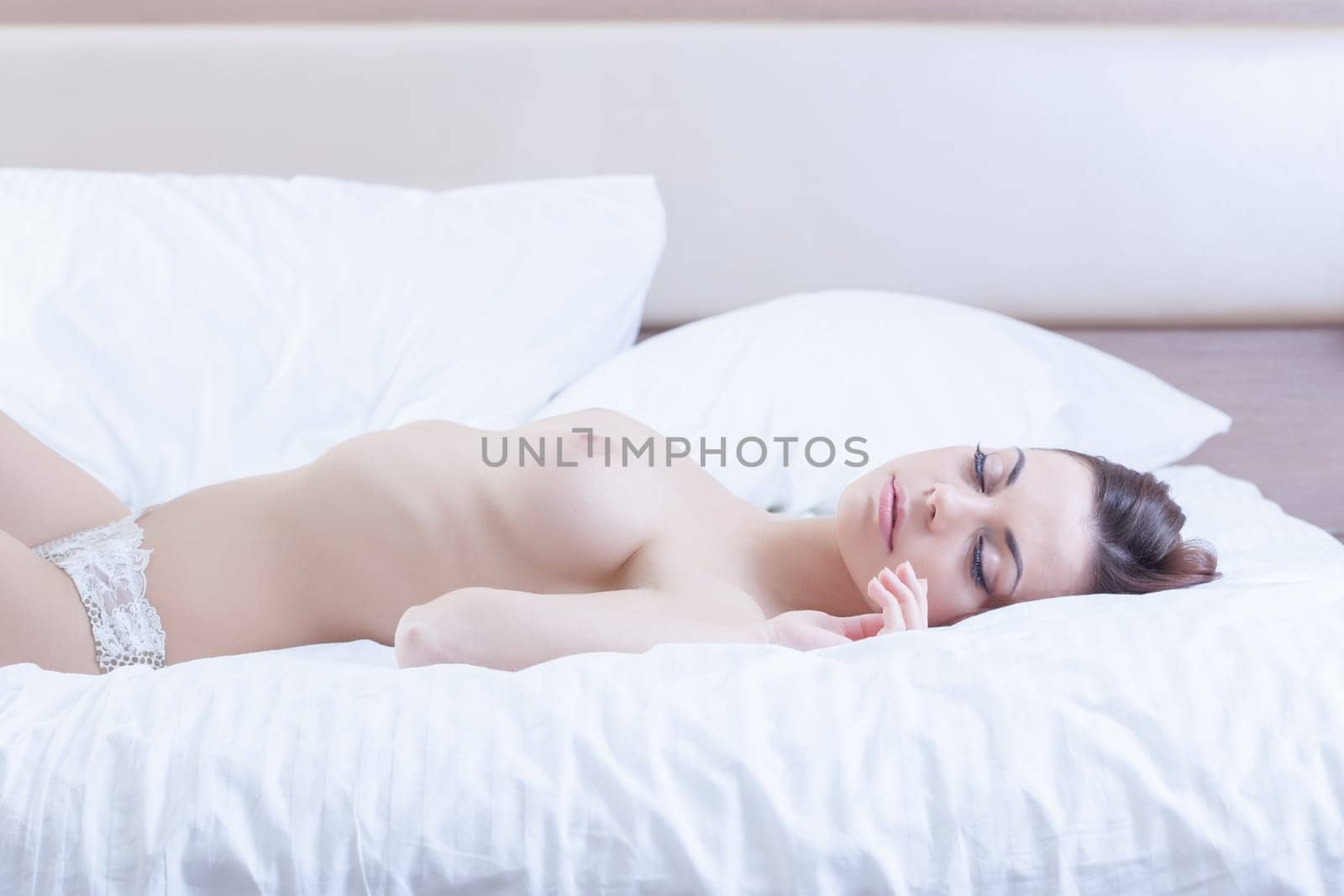 Portrait of Beauty young woman sleep topless on morning bed