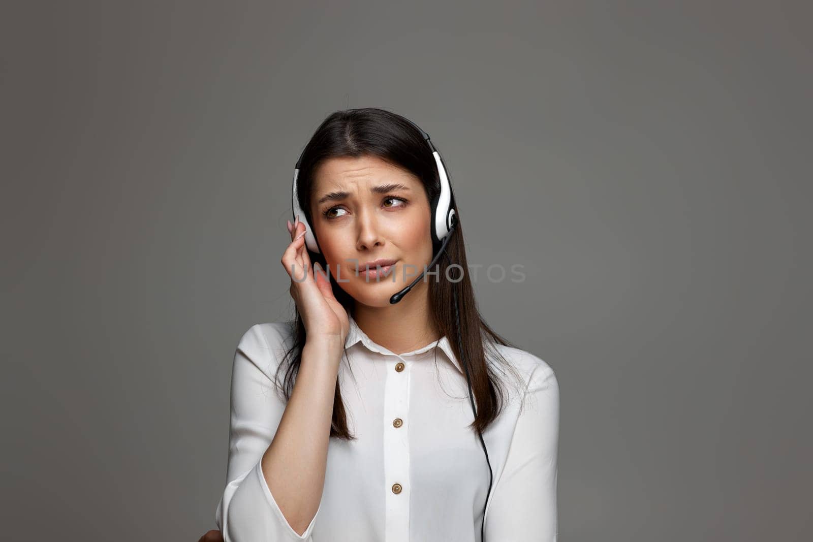 stressful frustrated female call center agent is consulting clients online. Call center, business people concept