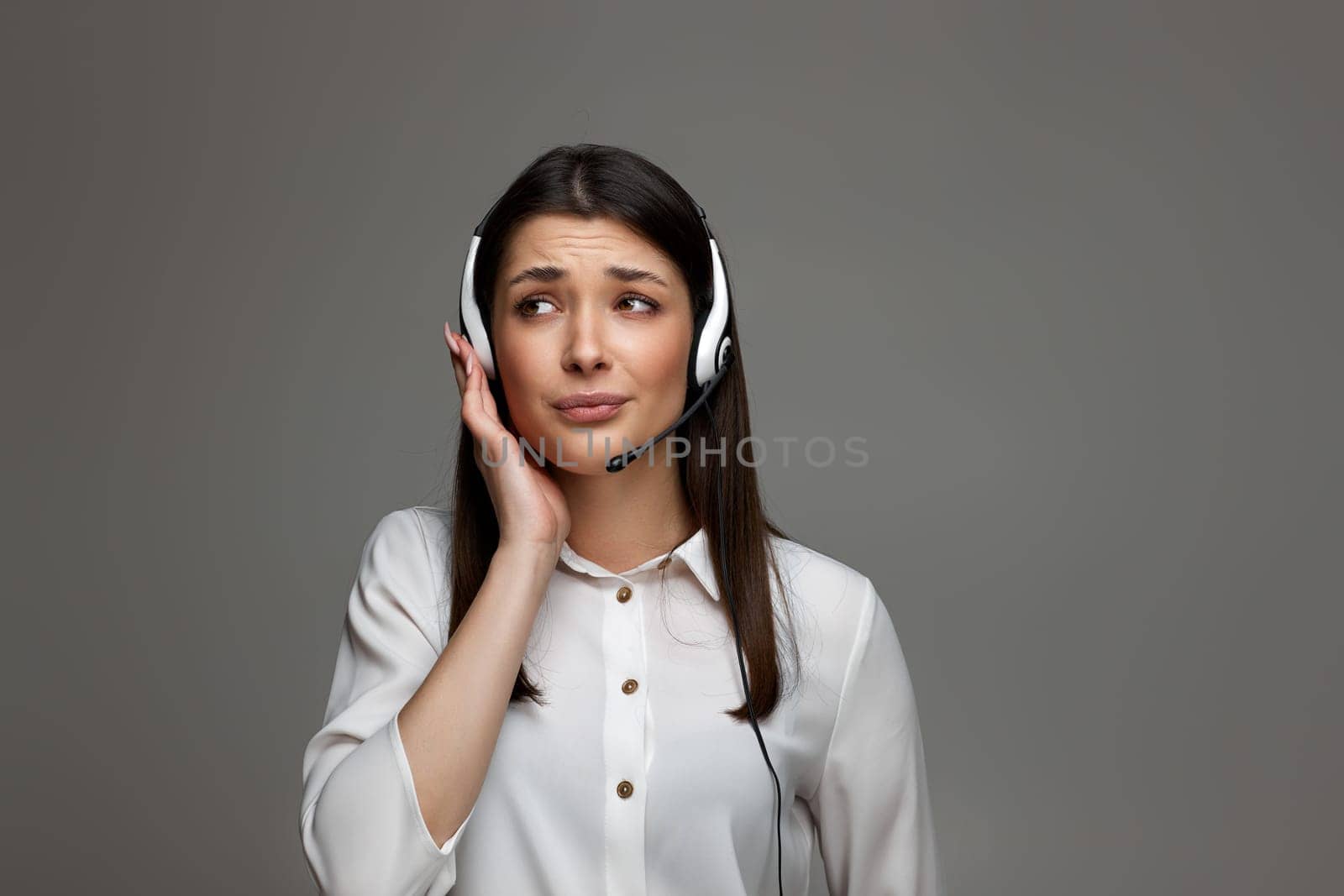 tired upset frustrated woman with headset is consulting clients online. Call center