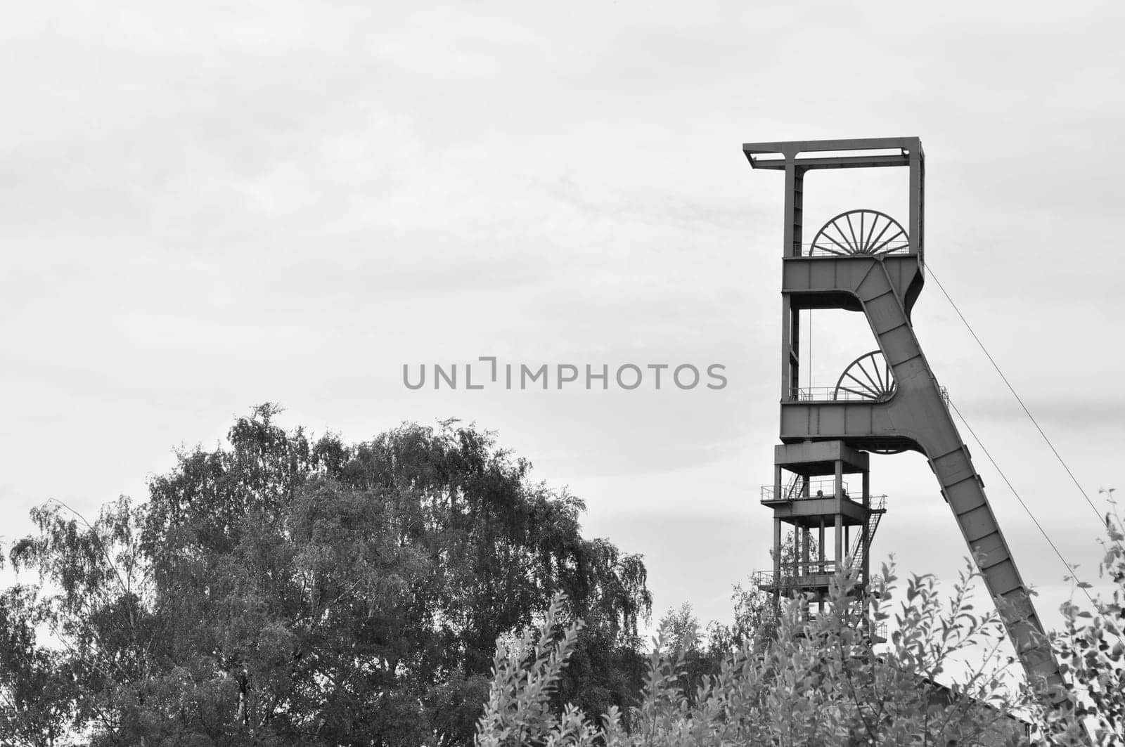 Grayscale shot of the winding tower of an old colliery in Essen, Ruhr area, NRW, Germany.