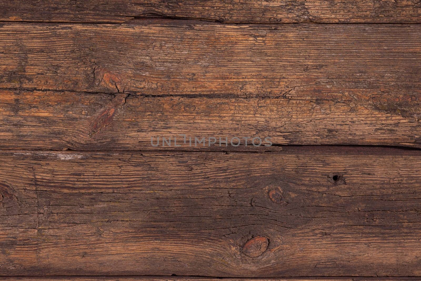 Several horizontally stacked old boards in clothes of brown color. Background of natural material slightly tattered.