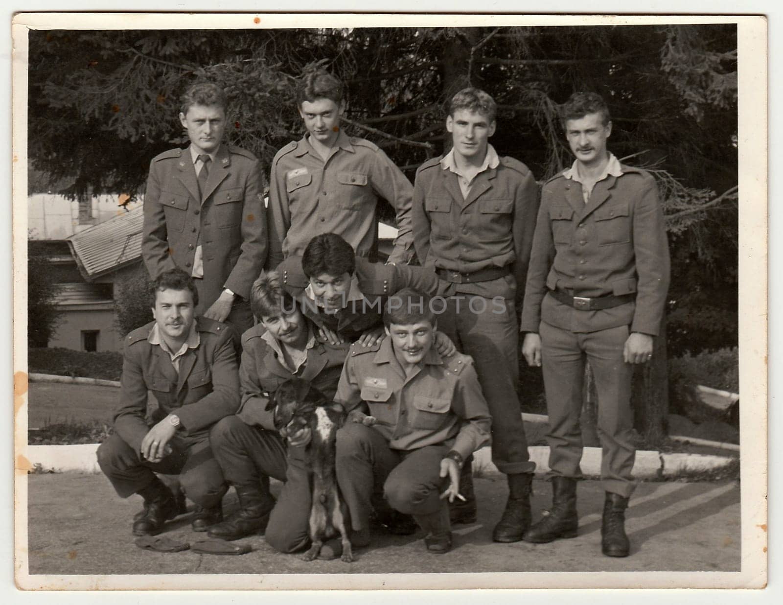 Retro photo shows soldiers pose outdoors. Black and white vintage photography. by roman_nerud