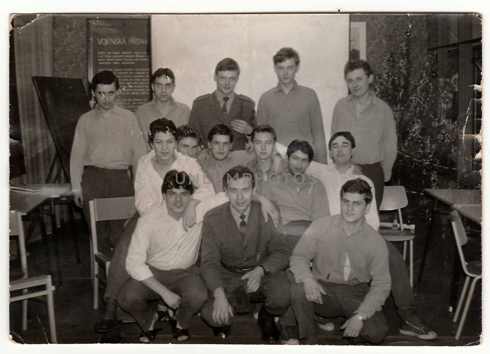 Retro photo shows soldiers pose indoors. Black and white vintage photography. by roman_nerud