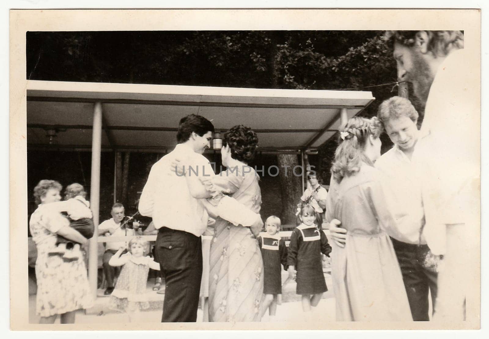 Retro photo shows people dance on wedding celebration. Black and white vintage photography. by roman_nerud