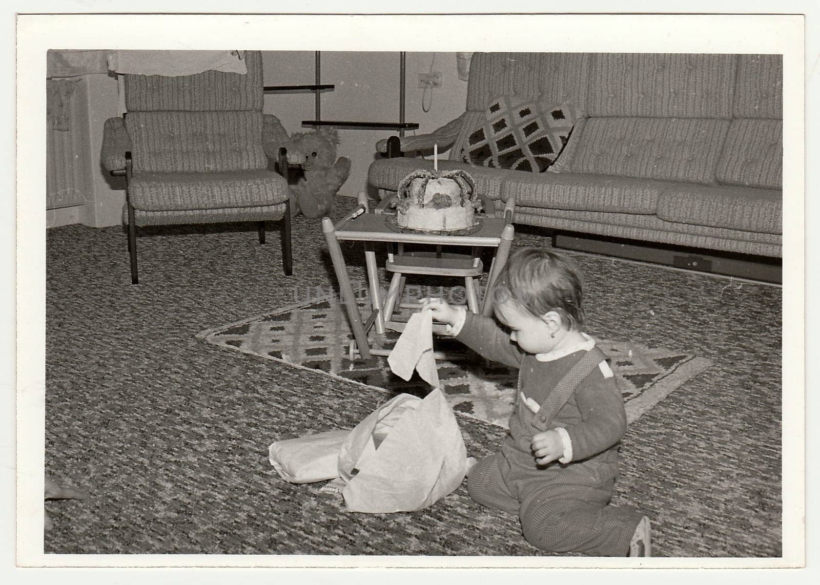 THE CZECHOSLOVAK SOCIALIST REPUBLIC - CIRCA 1970s: Retro photo shows small girl during her first birthday. Black and white vintage photography.