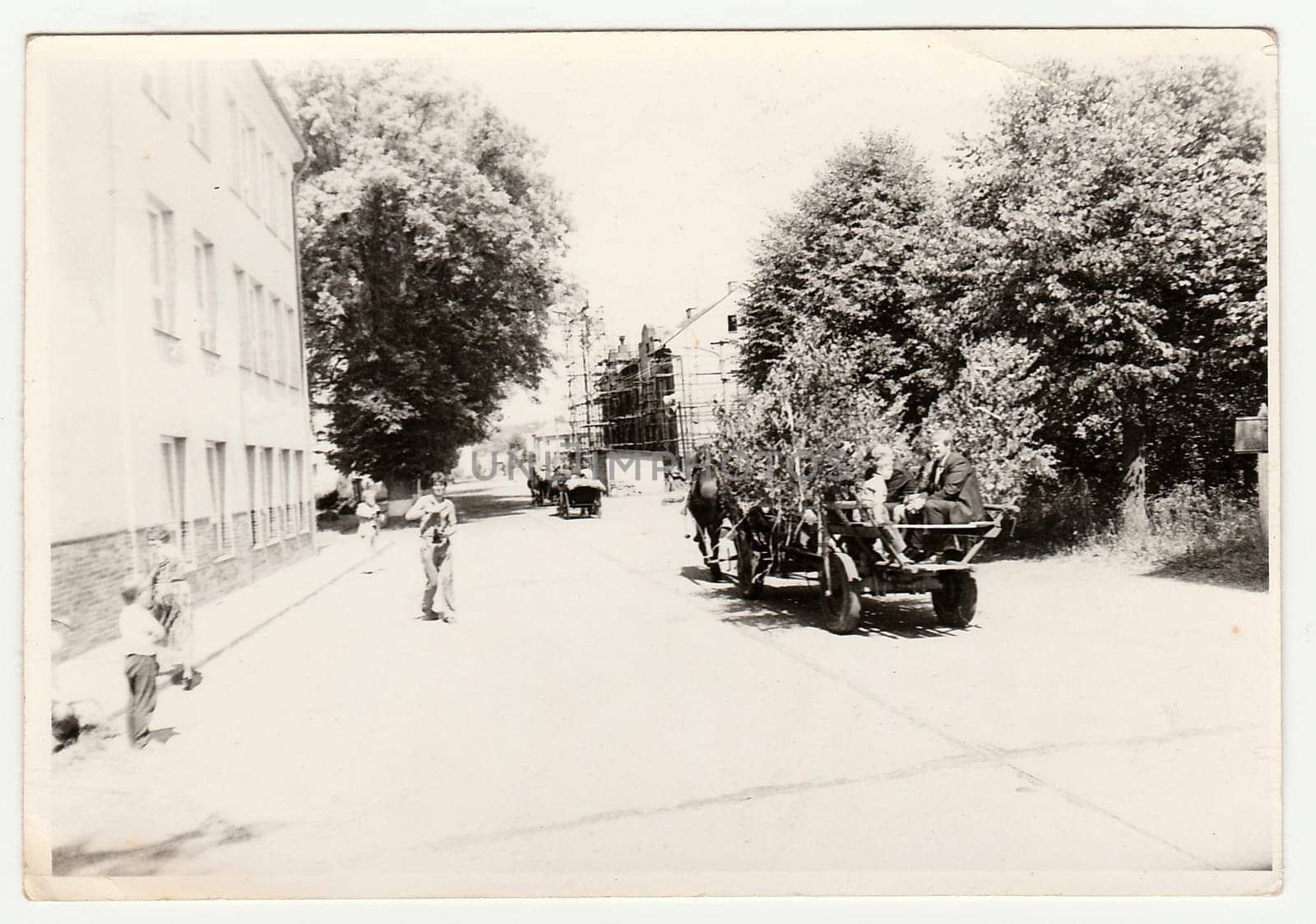 THE CZECHOSLOVAK SOCIALIST REPUBLIC - CIRCA 1970s: Retro photo shows people ride on rural wedding celebration. Black and white vintage photography.