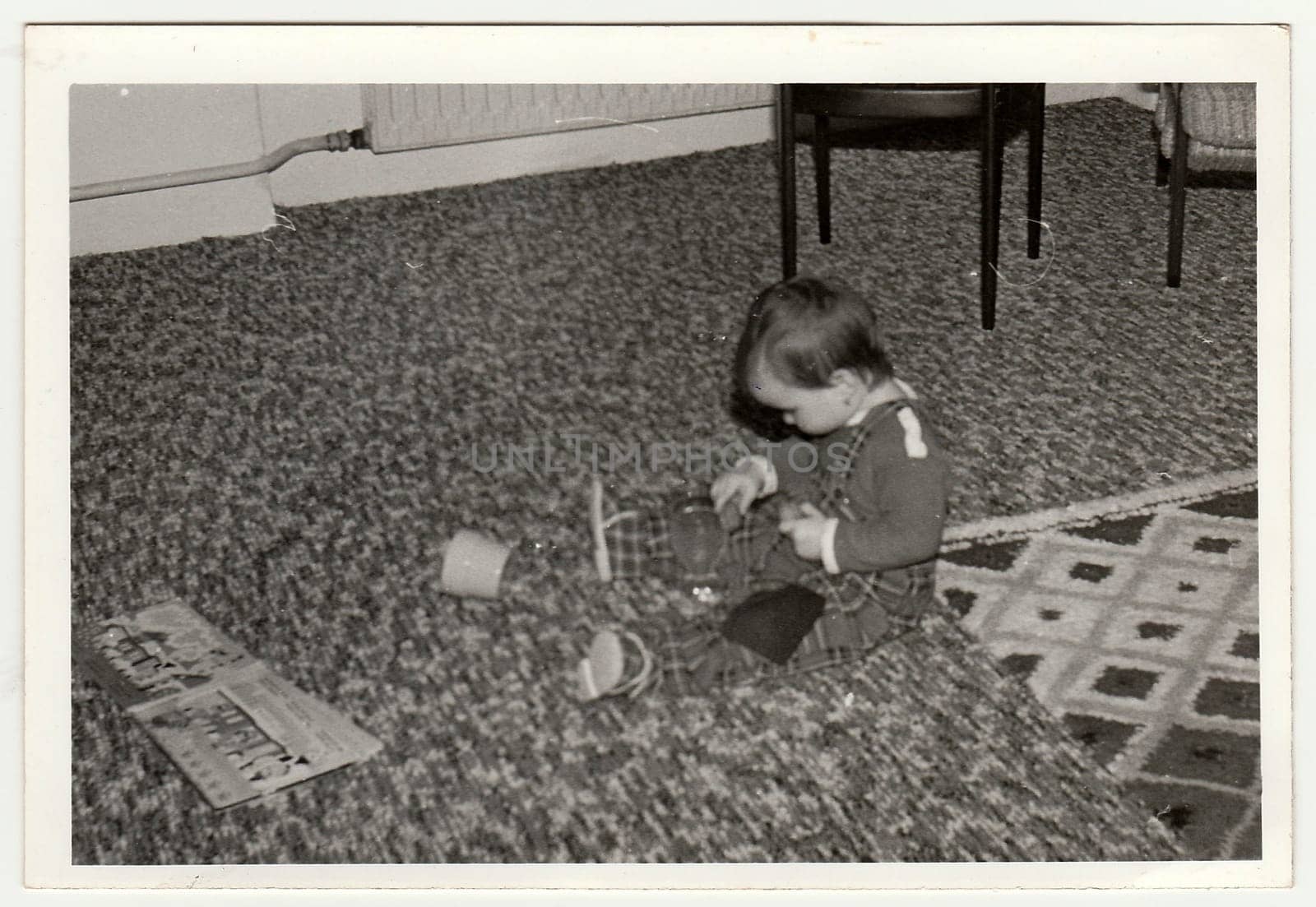 THE CZECHOSLOVAK SOCIALIST REPUBLIC - CIRCA 1970s: Retro photo shows child who plays with toy. Black and white vintage photography.