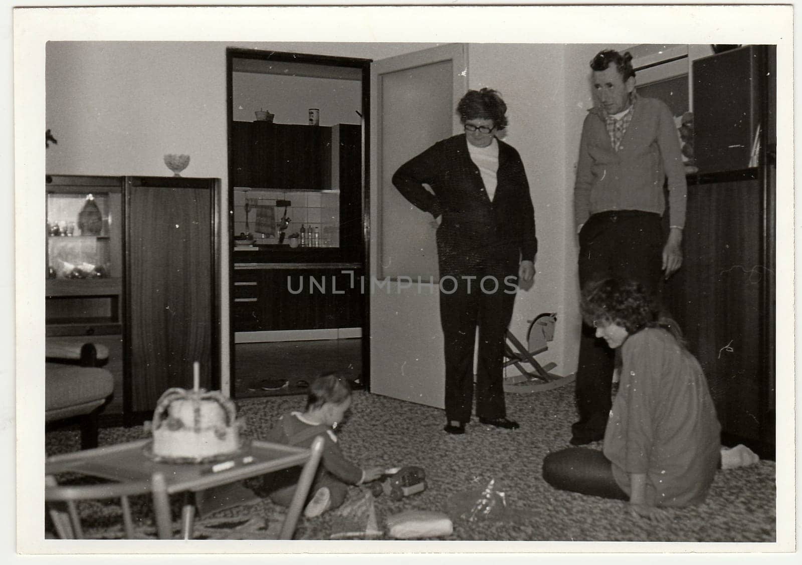 THE CZECHOSLOVAK SOCIALIST REPUBLIC - CIRCA 1970s: Retro photo shows small girl during her first birthday. Black and white vintage photography.