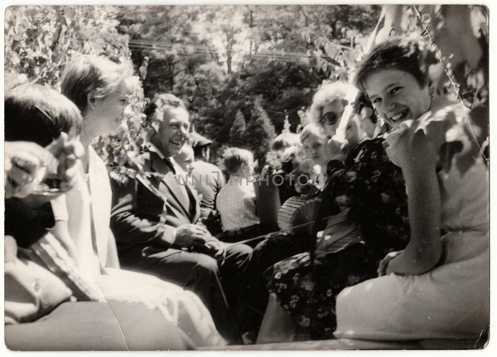 Retro photo shows people ride on rural wedding celebration. Black and white vintage photography. by roman_nerud