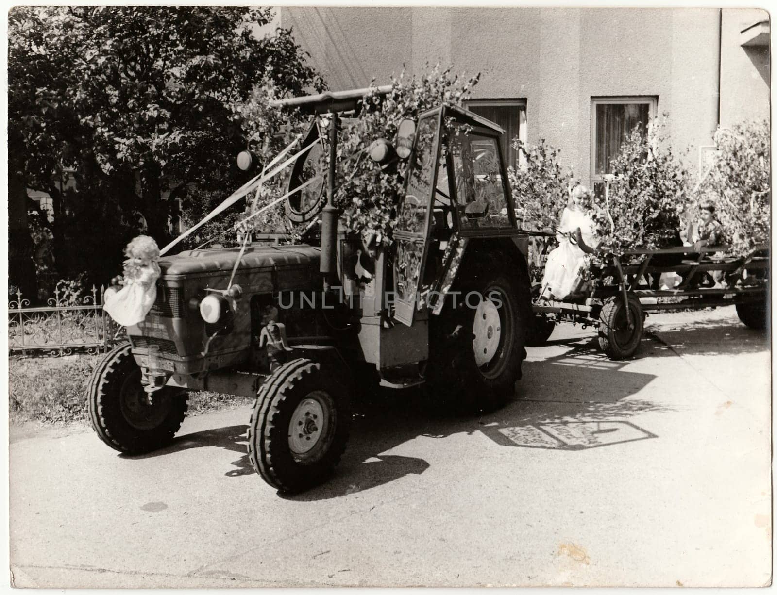 Retro photo shows bride rides on a rural wedding celebration. Black and white vintage photography. by roman_nerud