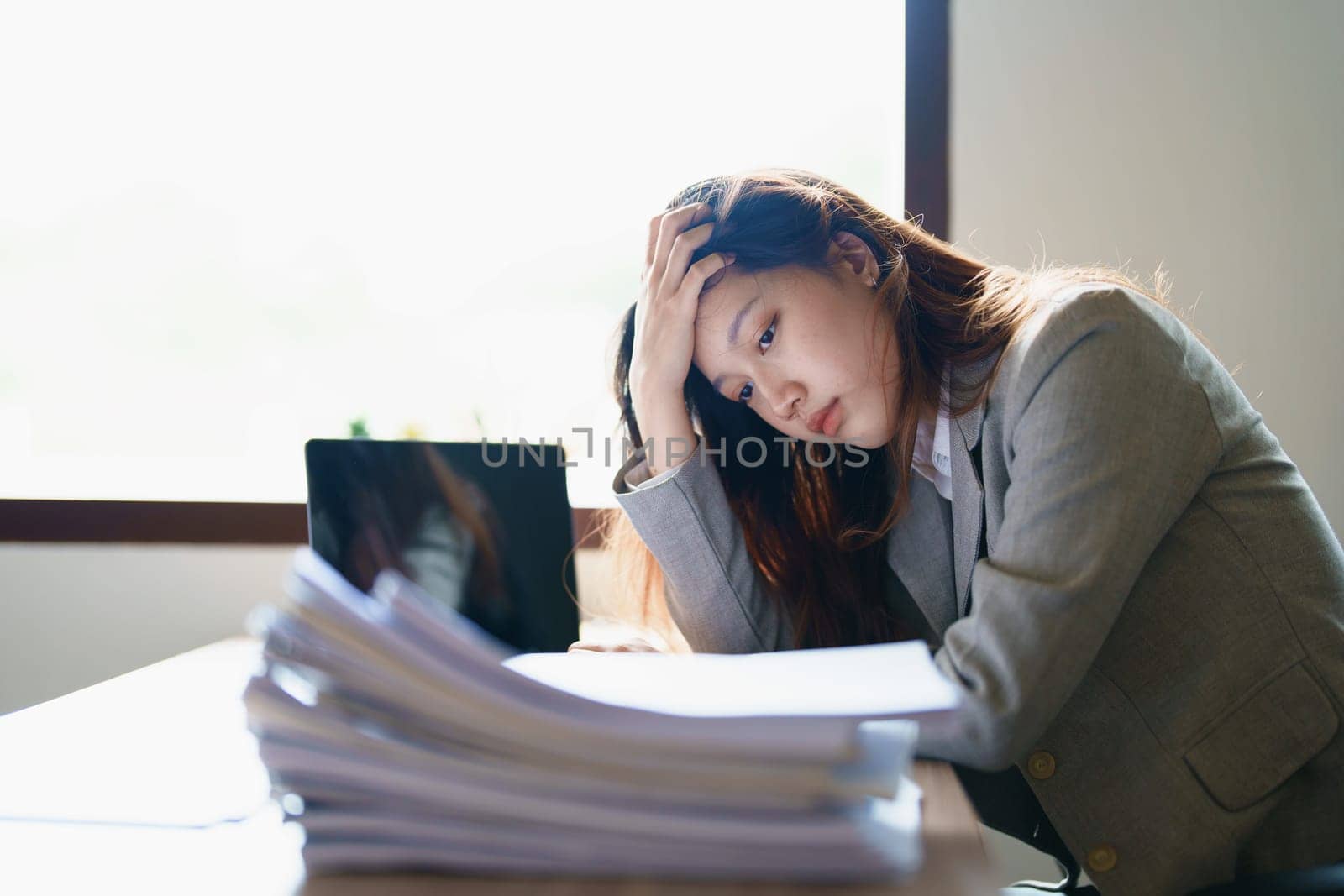 Portrait of sme business owner, man using computer and financial statements Anxious expression on expanding the market to increase the ability to invest in business by Manastrong