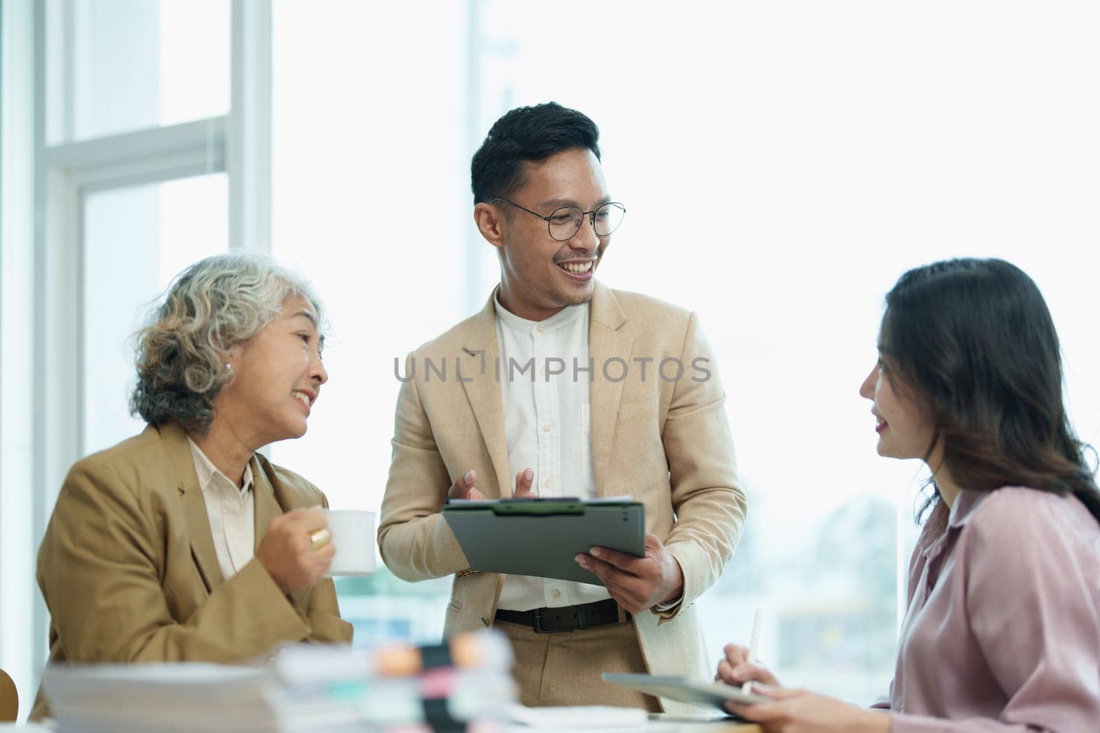 Asian entrepreneurs and business people meeting in a conference room in business planning, financial budget and investment risk assessment to analyze customer groups to increase company growth by Manastrong