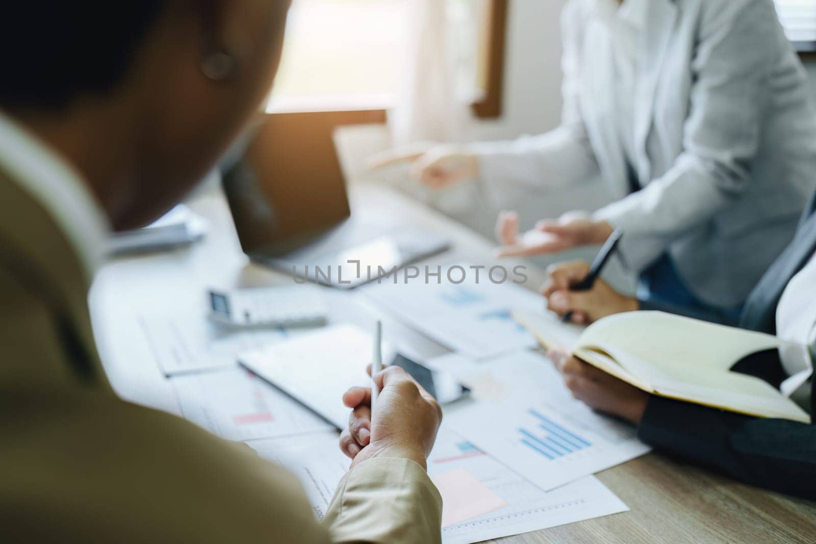 Asian entrepreneurs and business people meeting in a conference room in business planning, financial budget and investment risk assessment to analyze customer groups to increase company growth by Manastrong