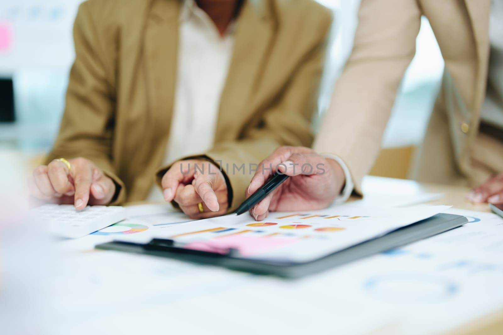 Asian entrepreneurs and business people meeting in a conference room in business planning, financial budget and investment risk assessment to analyze customer groups to increase company growth by Manastrong