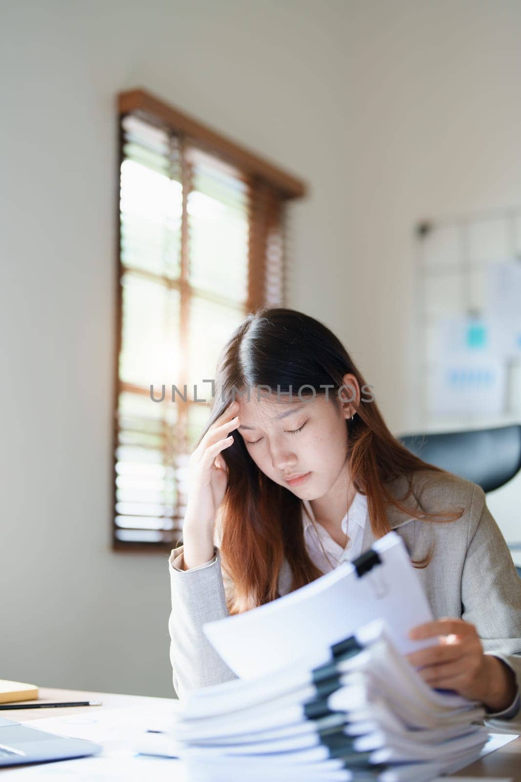 Portrait of sme business owner, man using computer and financial statements Anxious expression on expanding the market to increase the ability to invest in business by Manastrong