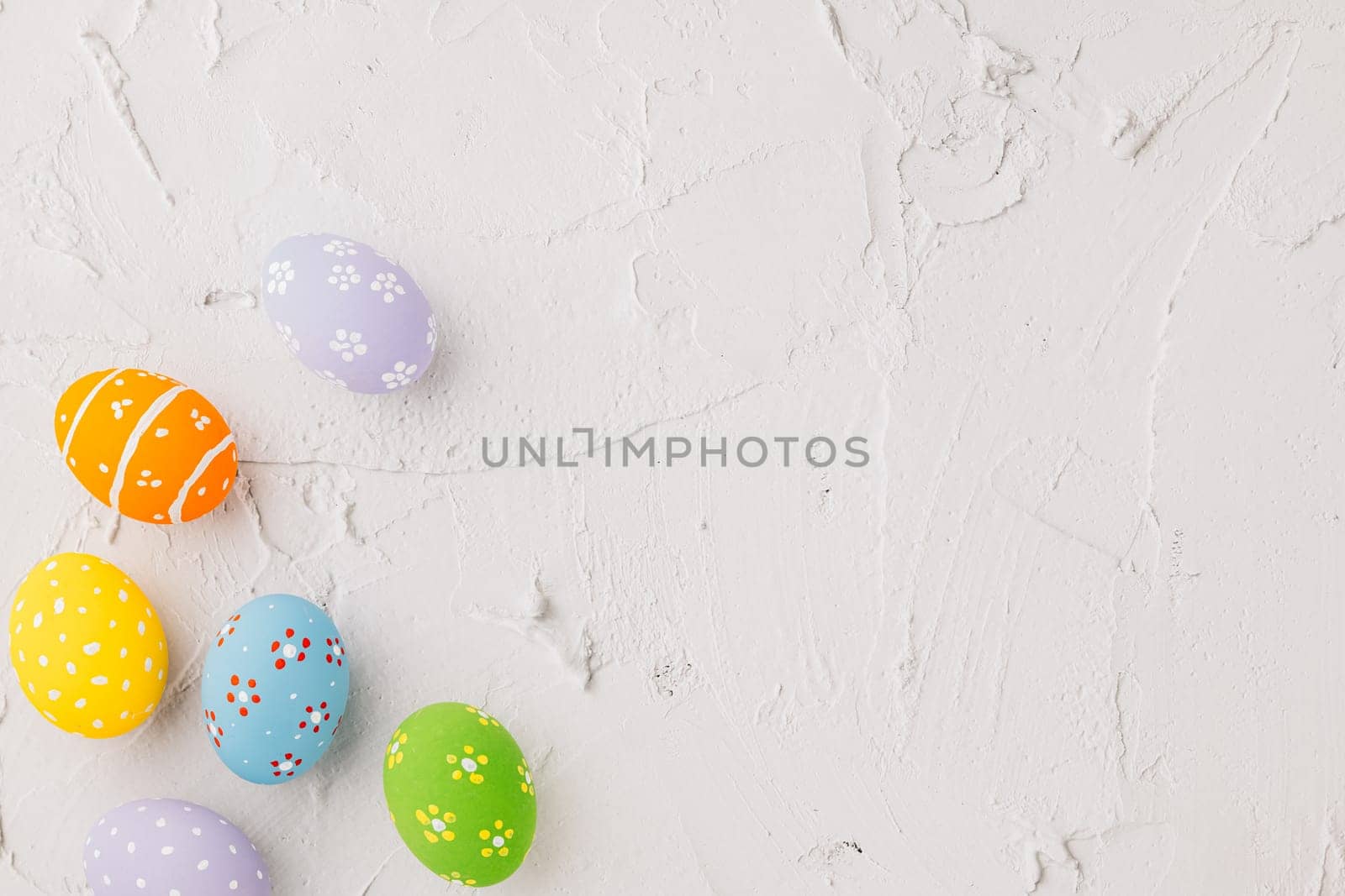 Happy Easter Day Concept. Top view holiday banner background web design white colorful easter eggs painted on cement background with empty copy space, celebration greeting card, overhead, template