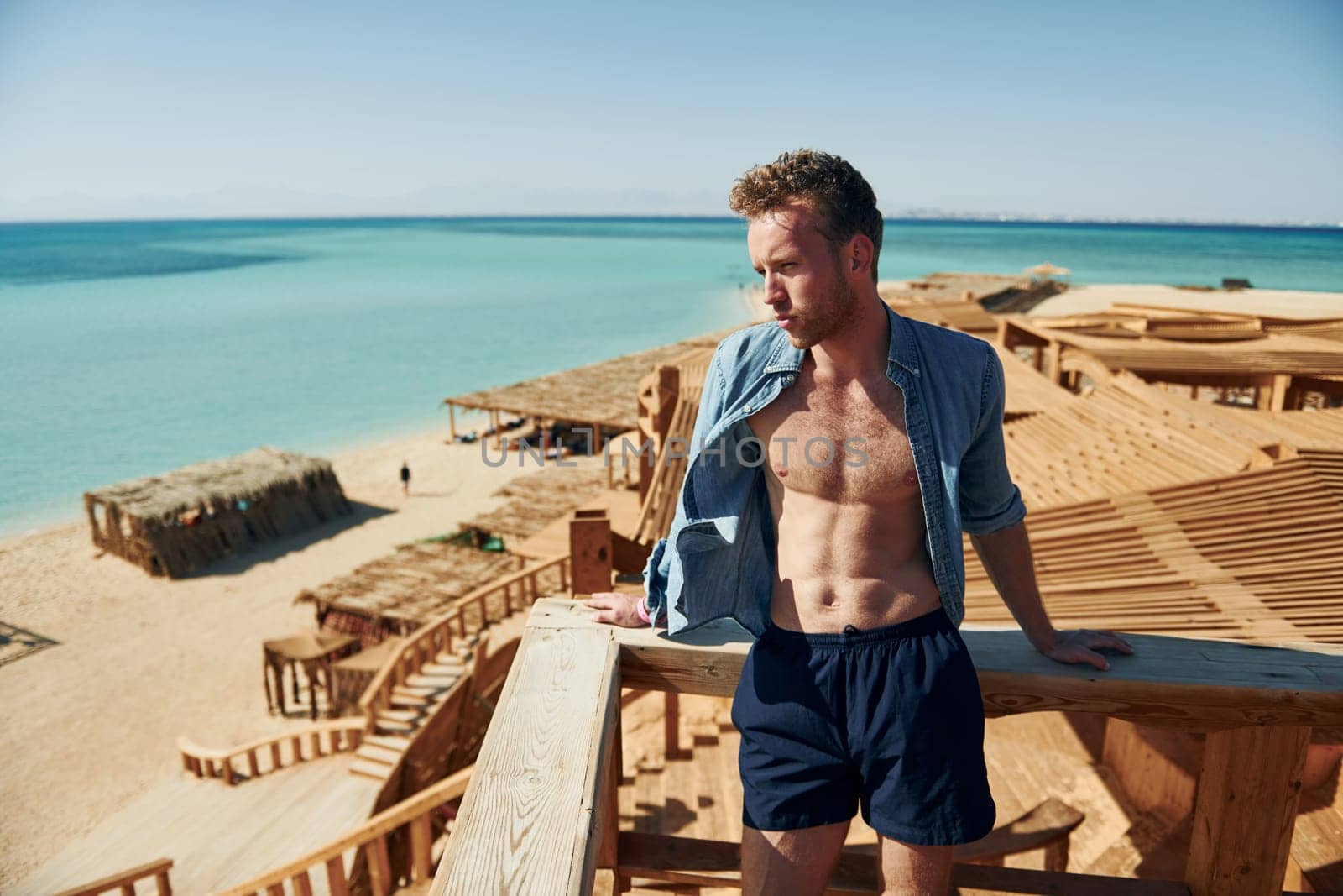 Young european man have vacation and enjoying free time on the beach of sea.