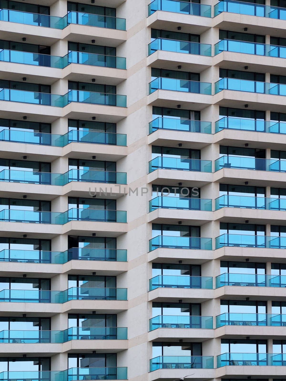 modern facade of a high-rise building with glass balconies for an architectural urban