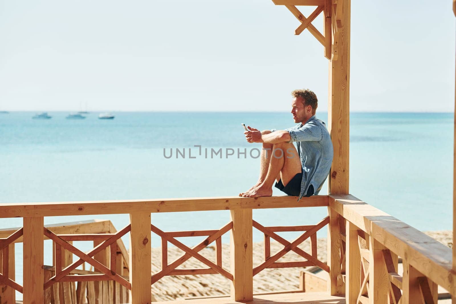 Young european man have vacation and enjoying free time on the beach of sea.