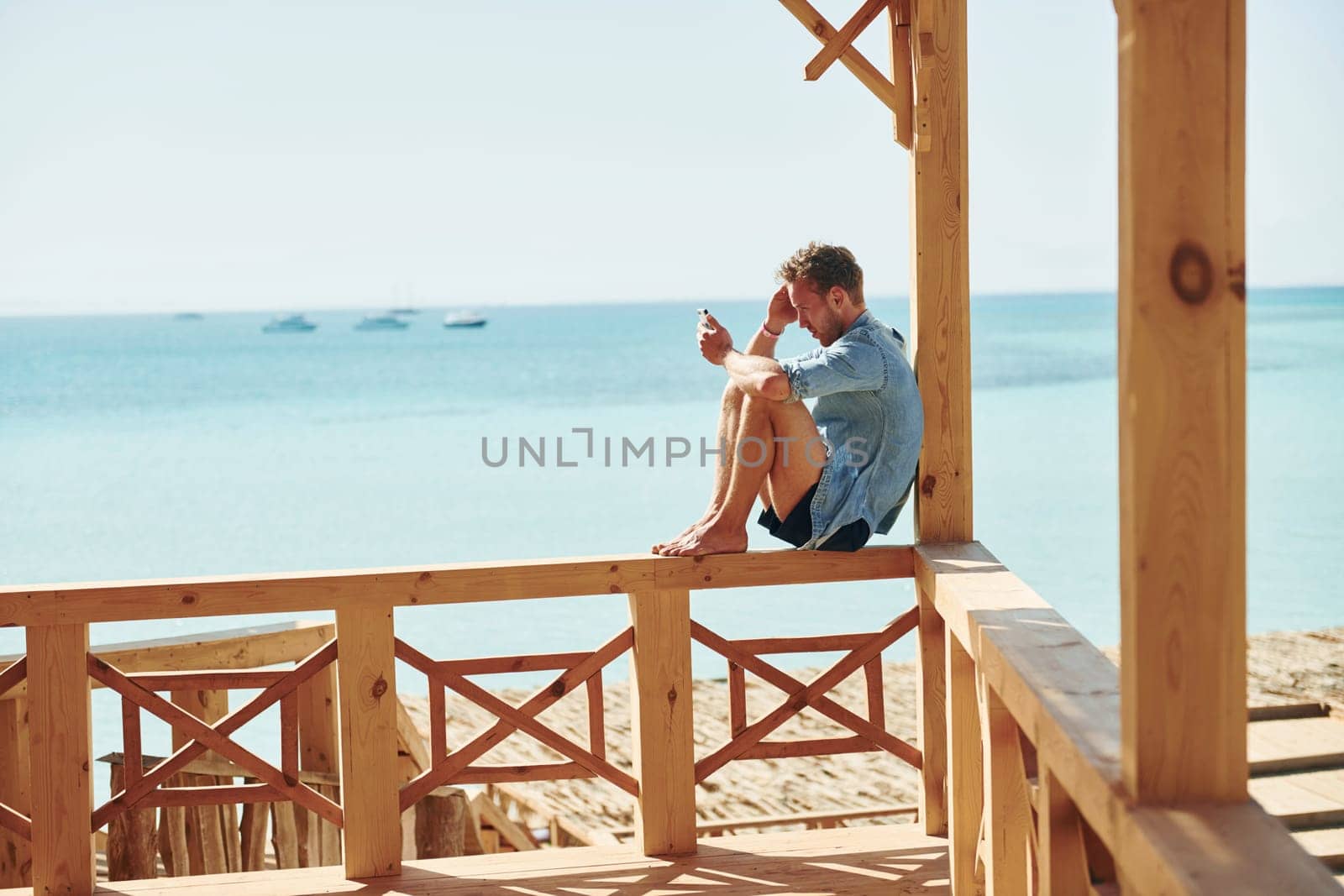 Young european man have vacation and enjoying free time on the beach of sea.