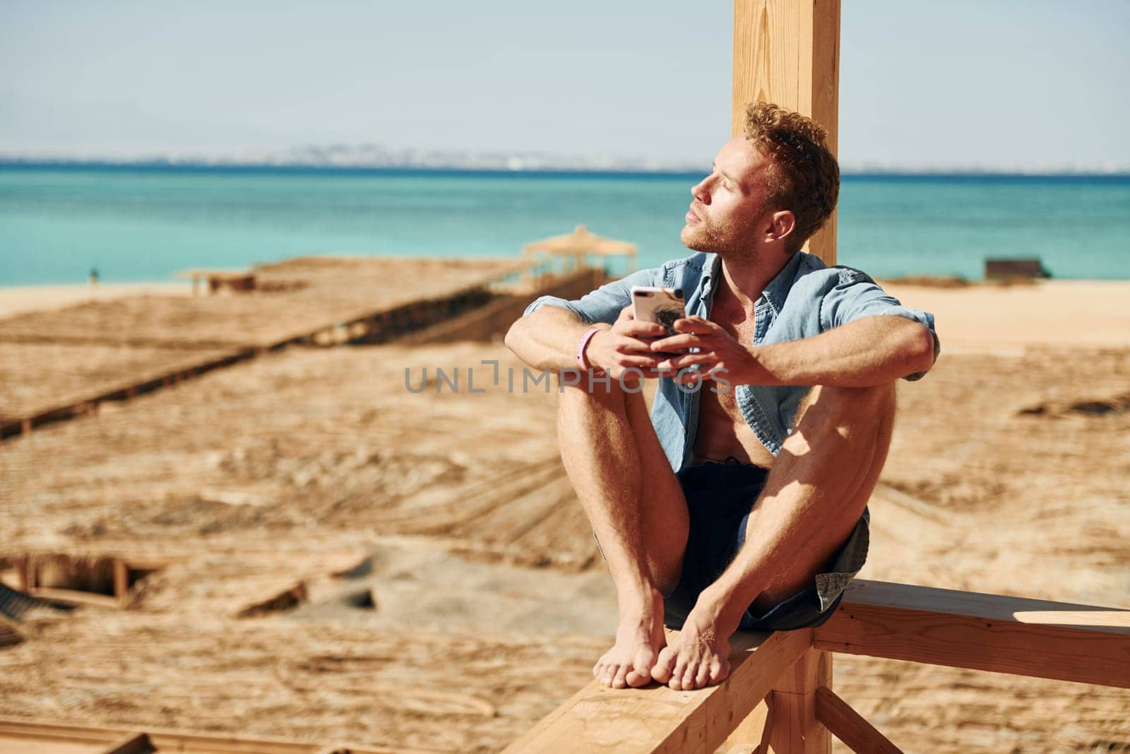 Young european man have vacation and enjoying free time on the beach of sea.
