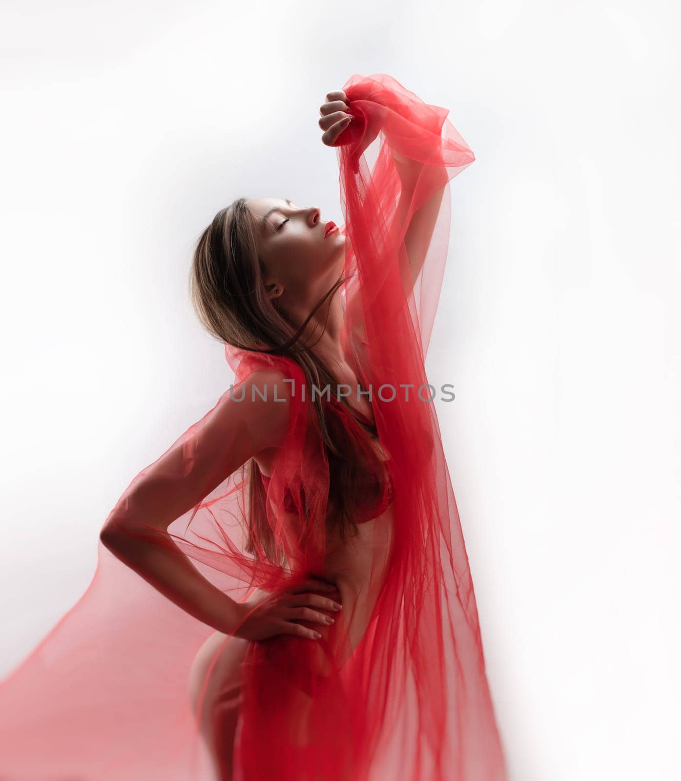 sexy girl with red transparent fabric on a white background copy paste
