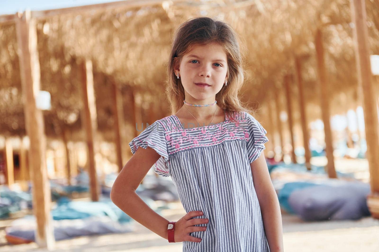 Little girl have vacation on the sea at sunny daytime. Conception of travel.