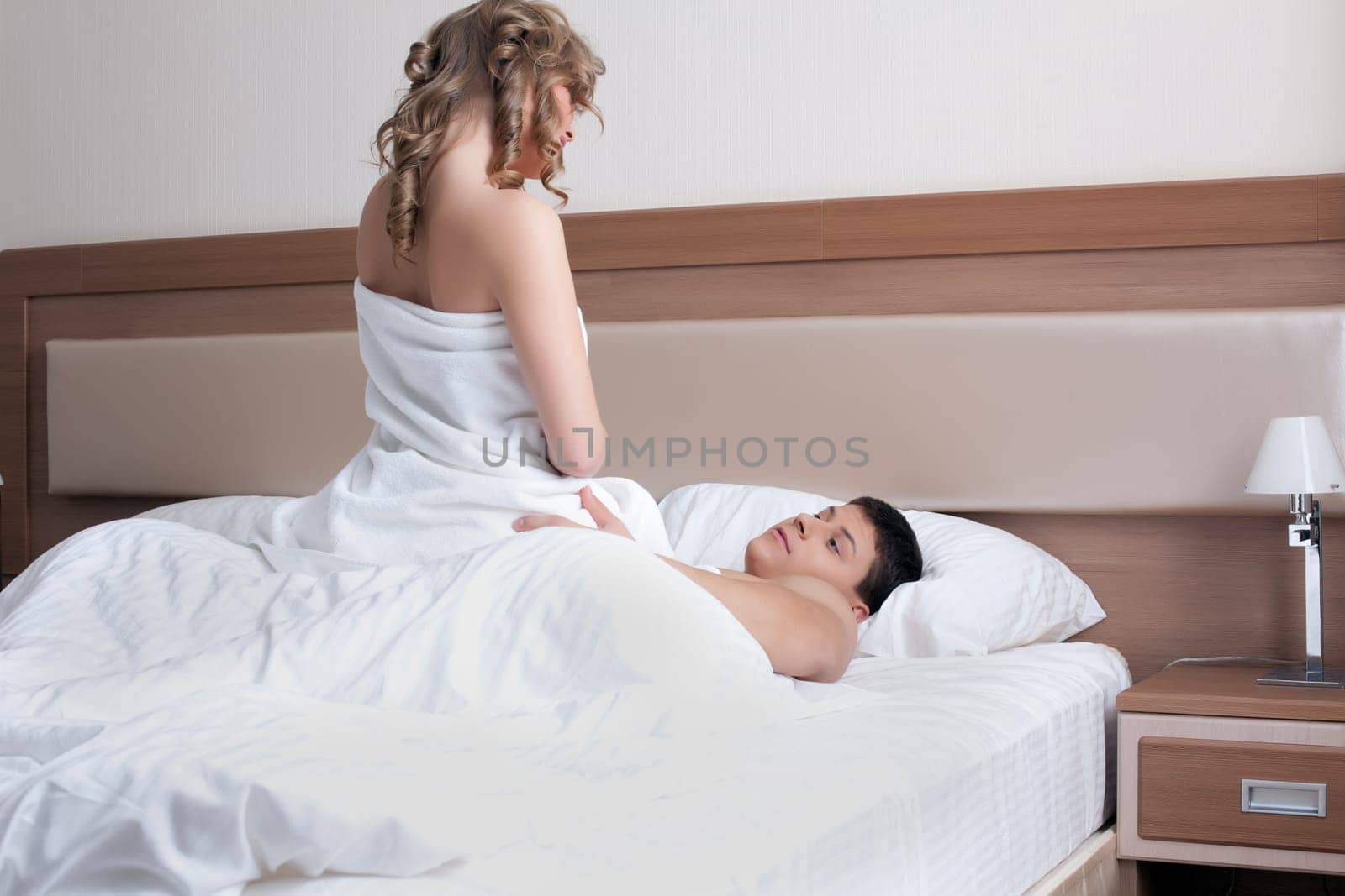 Portrait of young couple making love in bed