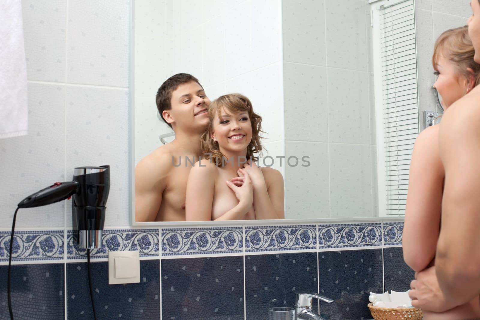 Portrait of Sexy young couple in bathroom smile before mirror