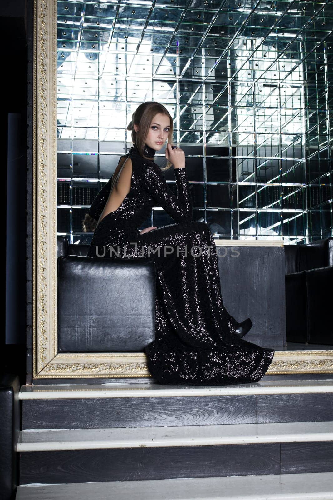 Full length portrait of beautiful young woman in long black dress