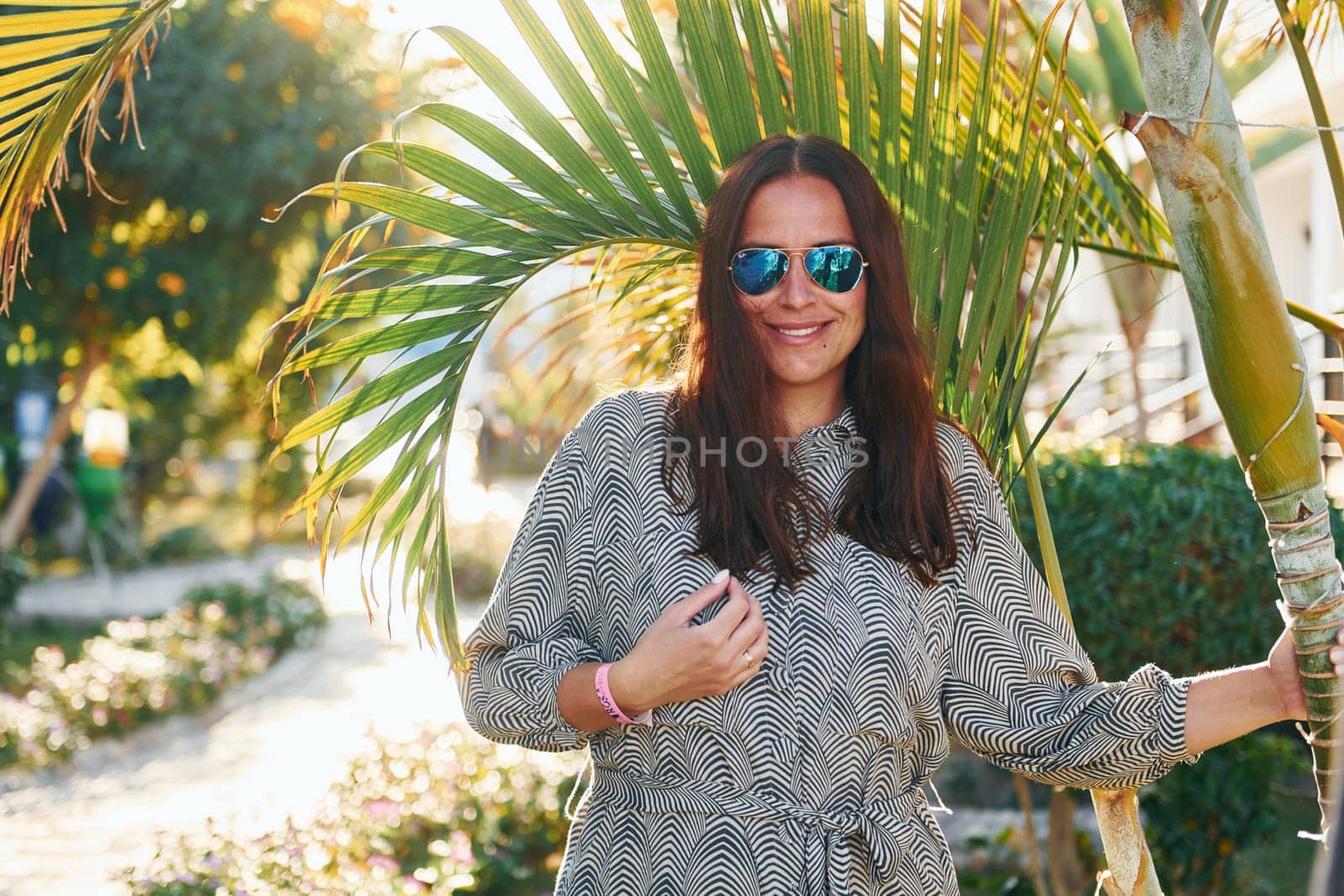 Happy mature woman is outdoors enjoying her vacation at sunny daytime.