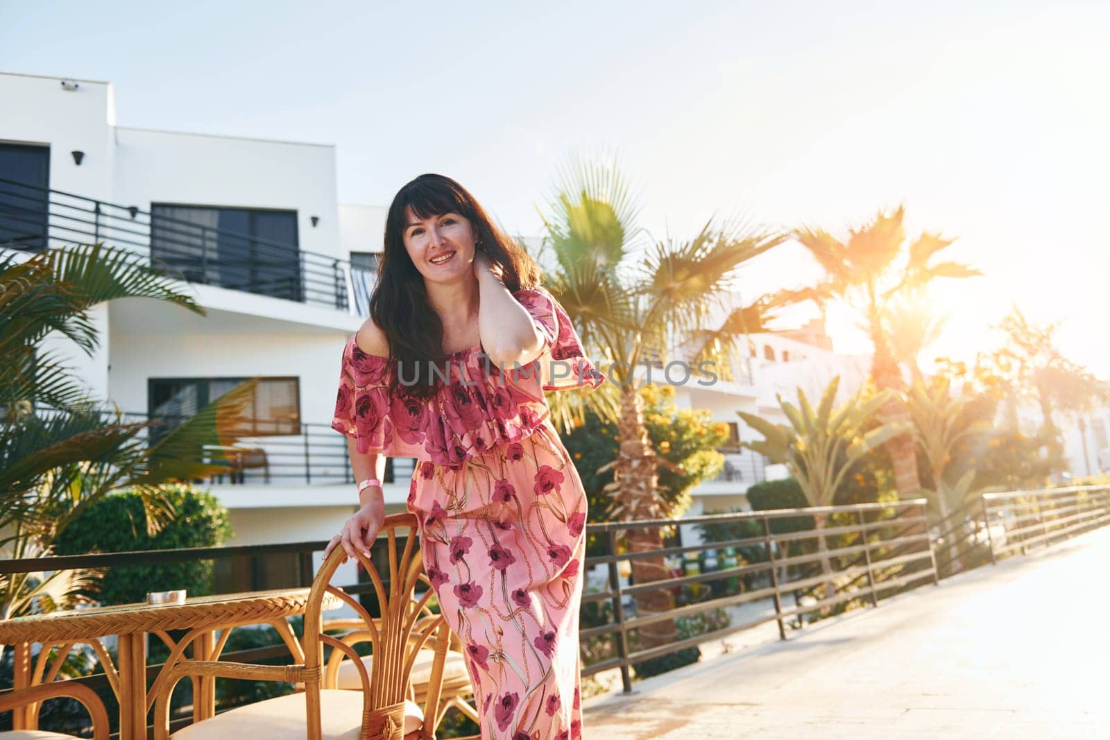 Happy mature woman is outdoors enjoying her vacation at sunny daytime.