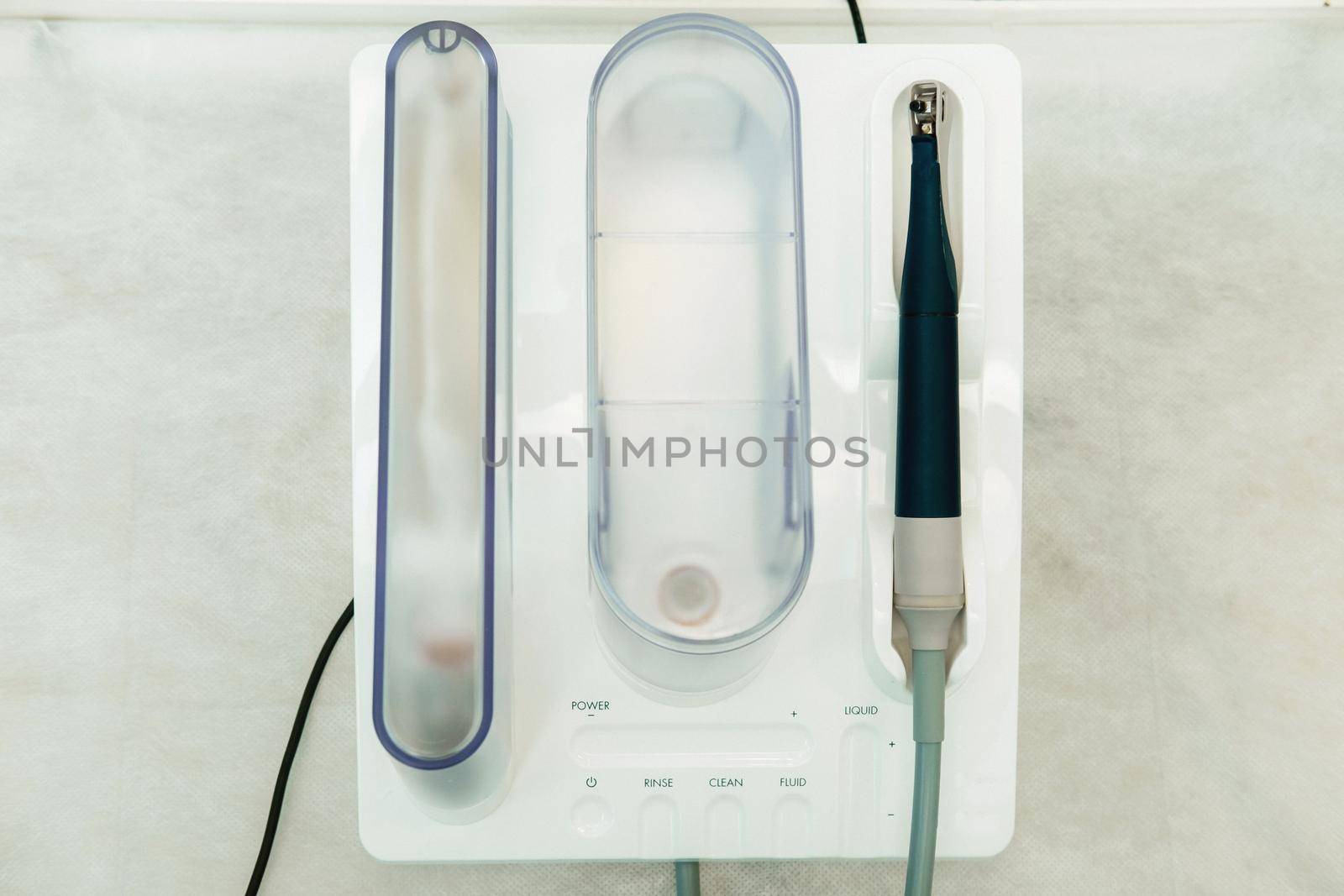 Ultrasonic scaler in the dental office. Dentistry Concept by Lobachad