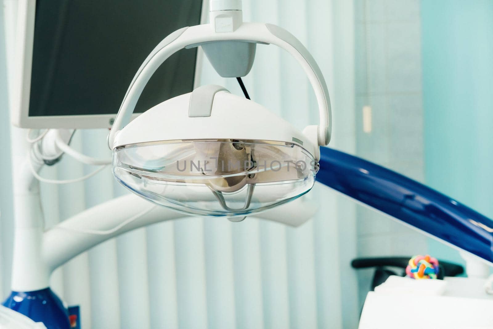 A lamp in the interior of the dentist's office. Empty dentist's office by Lobachad