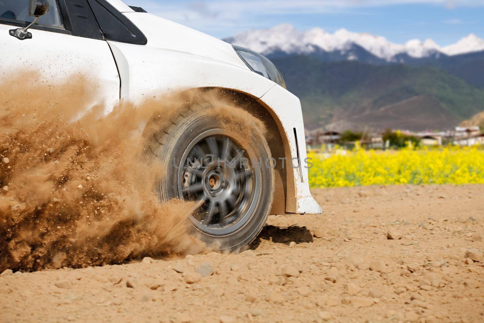 Rally racing car in dirt track.