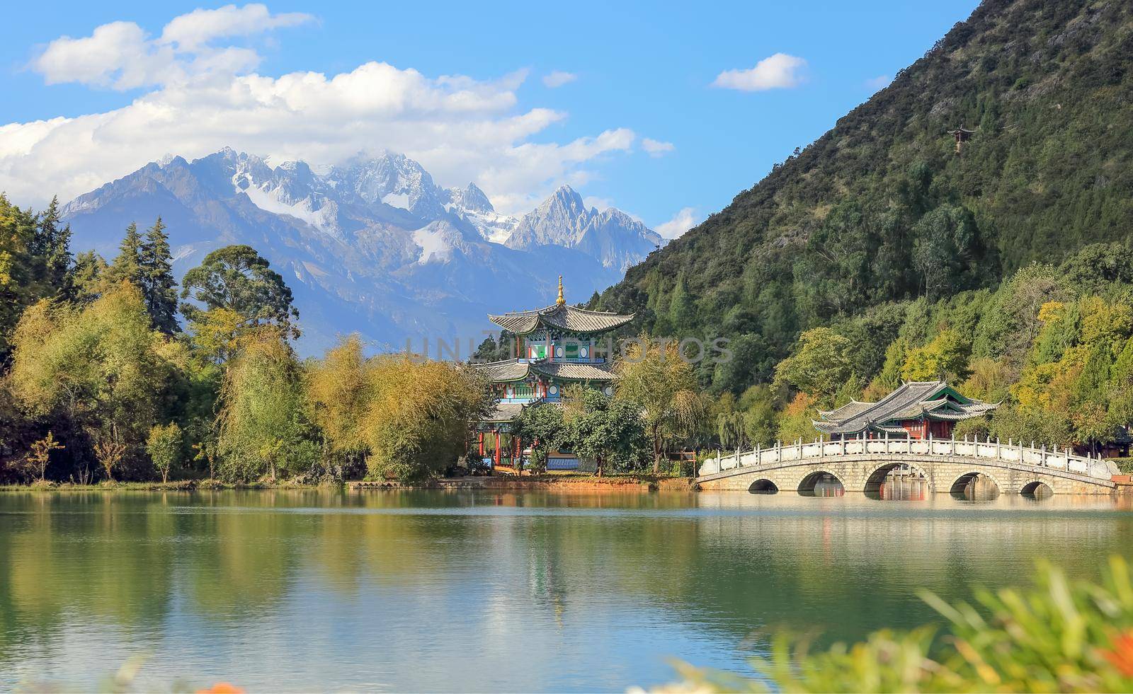 Jade Dragon Snow Mountain and the Suocui Bridge over the Black Dragon Pool in the Jade Spring Park, Lijiang, Yunnan province, China. by toa55