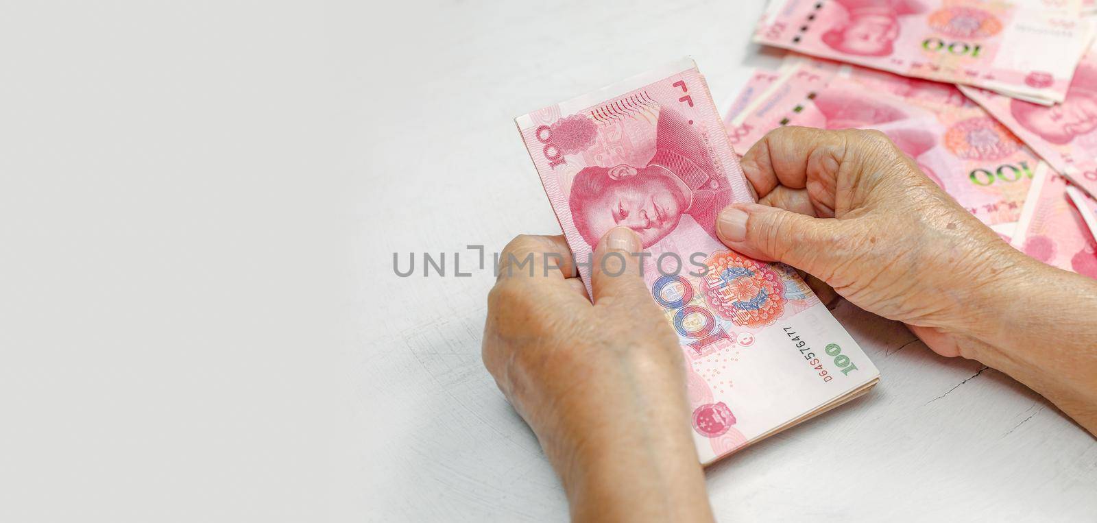 Chinese Senior woman counting money for payment