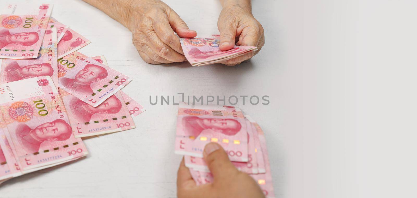 Chinese Senior woman counting money for payment