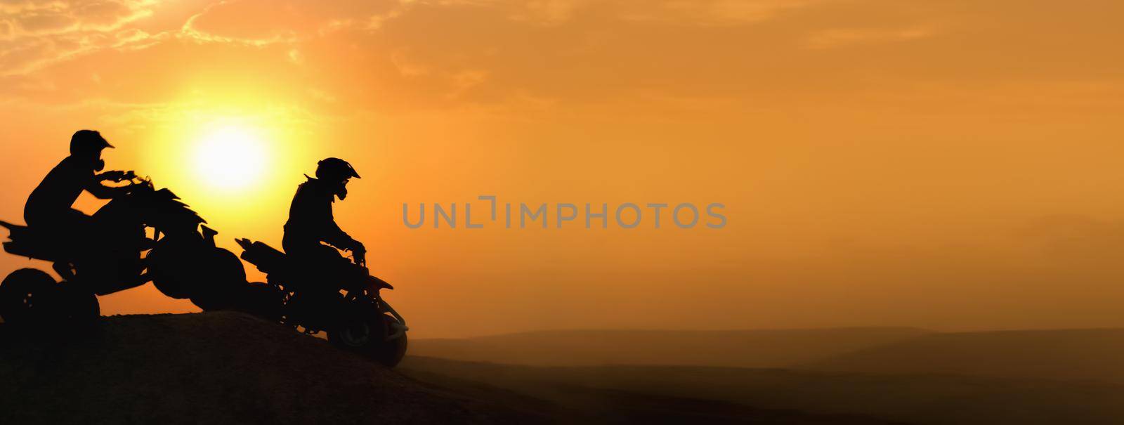 Silhouette ATV or Quad bikes Jump in sunset.