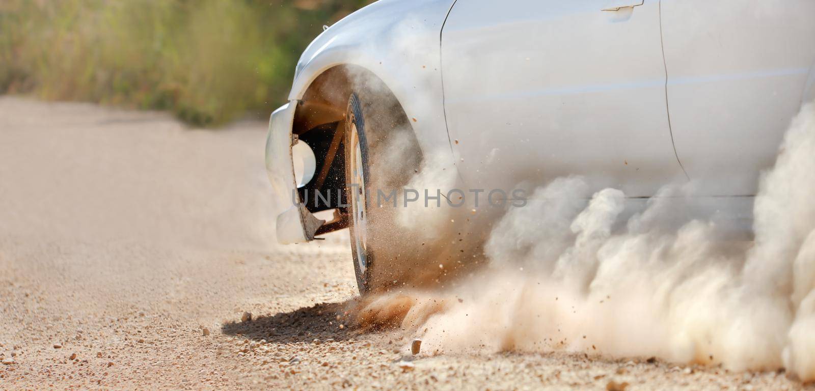 Rally racing car in dirt track.